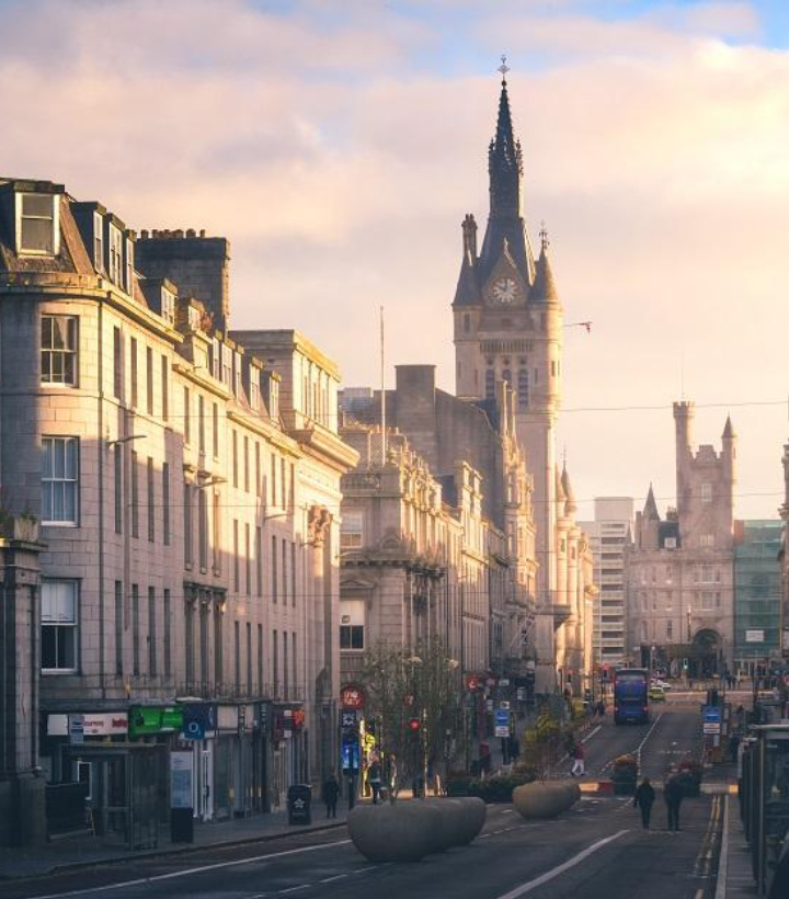 A consultant cardiologist in a UK office carefully reviews medical records and cardiology reports as part of a CPR Part 35-compliant expert witness instruction for an Aberdeen case.