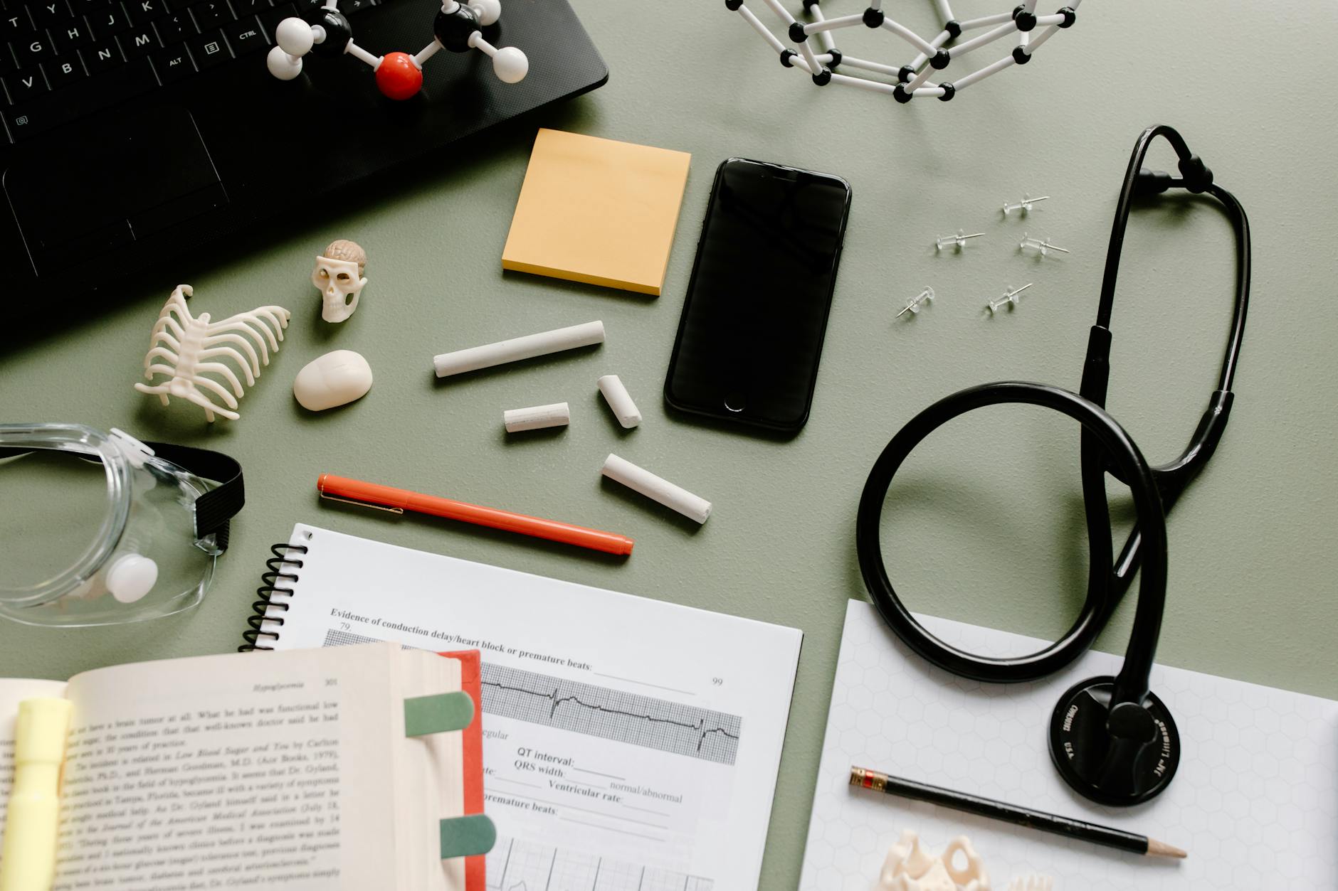 Cardiology expert critique report on a desk with stethoscope