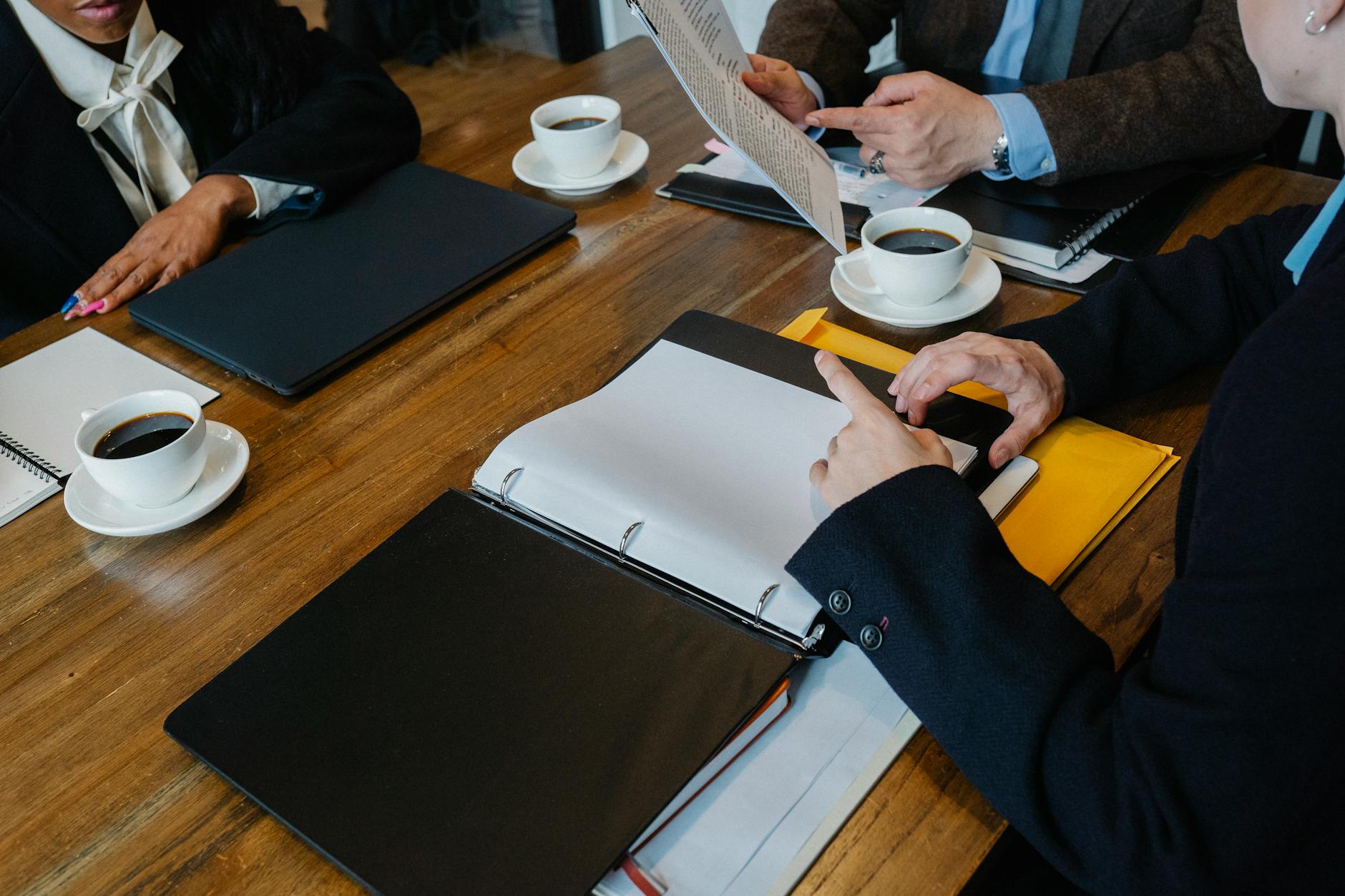 A UK consultant cardiologist reviews medico-legal records at a desk for an expert witness instruction.
