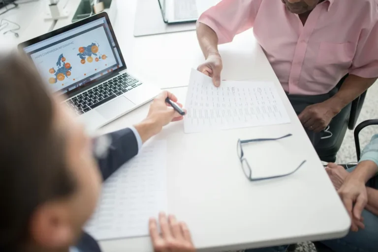 Lawyer reviewing documents with a client at a desk