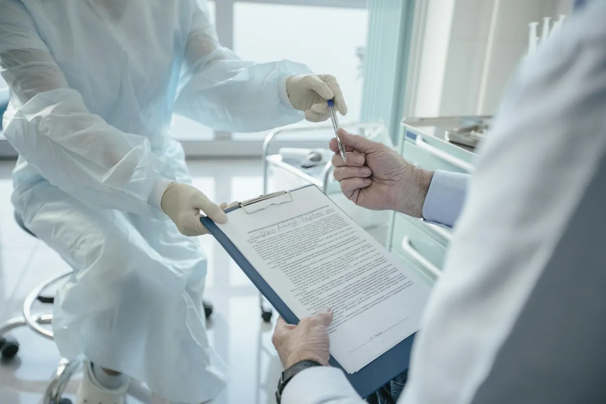 Clinicians reviewing a document on a clipboard