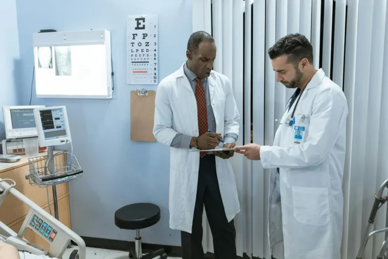 Two consultants discussing a case in a clinic room
